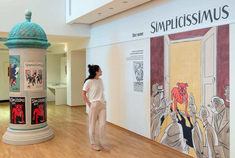 s:151:"Die Ausstellung "Der neue Simplicissimus - Satire für die Bonner Republik" zeigt Karikaturen, Titelseiten und Ausgaben aus der Zeit von 1954 bis 1967.";